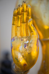 Closed up hand of Gold Buddha in Wat Phra That Bang Phuan in Nongkhai of Thailand