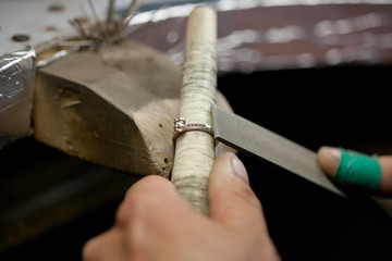 jeweller handmade work, crafting golden ring with tools, closeup