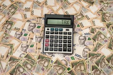500 hryvnia bills with calculator  as background. Close up. Top view.