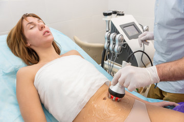 Radio frequency skin tightening, belly. Female body, cosmetology procedure.
