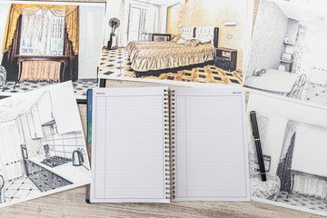 Unfinished  draft of classic room sketch, empty notepad, color tools on desk.