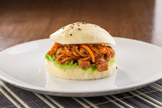 Bbq Pork Vietnamese Bao Burger With Pepper On White Plate On Wooden Table