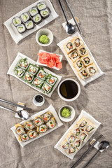 Japanese food restaurant sushi maki roll plate or platter set with soy sauce and wasabi on grey table