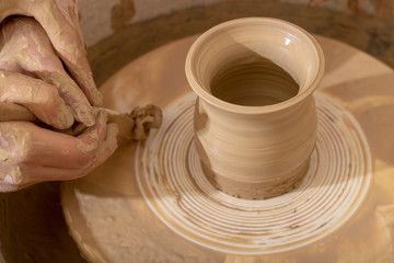 Fototapeta na wymiar Master class on modeling of clay on a potter's wheel In the pottery workshop