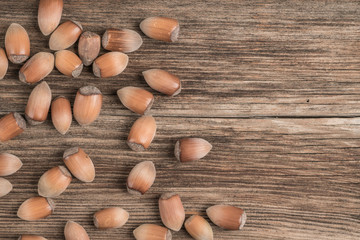raw hazelnuts on wooden background with copy space