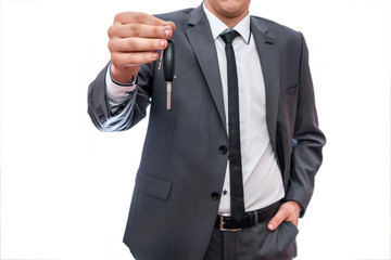 Businessman holding car keys isolated on white