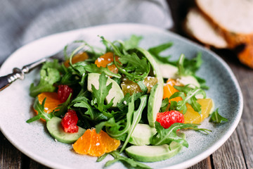 Vegetarian salad with arugula, oranges and grapefruit