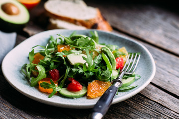 Vegetarian salad with arugula, oranges and grapefruit
