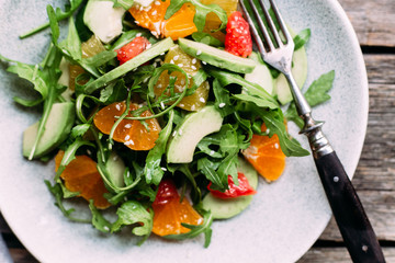 Vegetarian salad with arugula, oranges and grapefruit