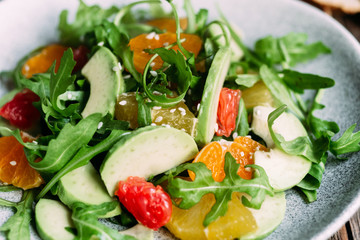 Vegetarian salad with arugula, oranges and grapefruit
