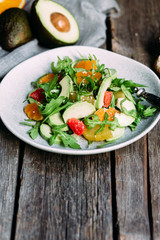 Vegetarian salad with arugula, oranges and grapefruit