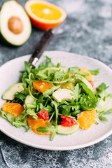 Vegetarian salad with arugula, oranges and grapefruit