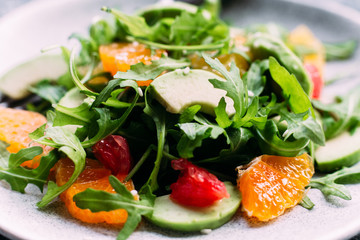 Vegetarian salad with arugula, oranges and grapefruit