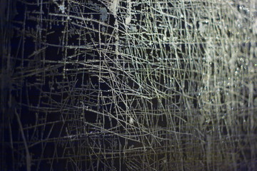 Abstract patterns on the glass.  Frozen windows illuminated from the outside by light in the dark.