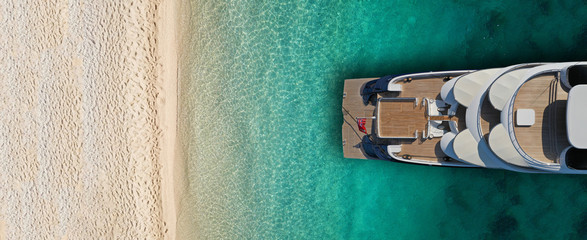 Aerial drone top view ultra wide photo of luxury yacht docked near exotic sandy turquoise beach - obrazy, fototapety, plakaty