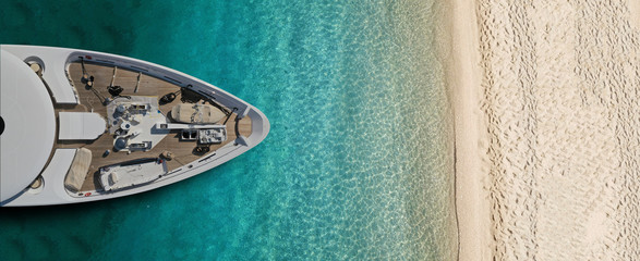 Aerial drone top view ultra wide photo of luxury yacht docked near exotic sandy turquoise beach