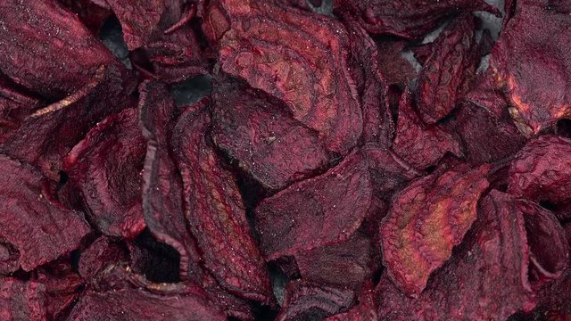 Portion of rotating beetroot chiops as seamless loopable 4K footage