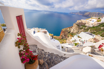 Oia town on Santorini island, Greece. Traditional and famous houses and churches with blue domes over the Caldera, Aegean sea