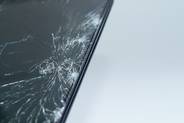 Broken display of a mobile phone on a white background, close-up