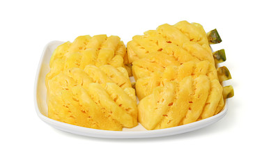 Pineapple with slices in dish isolated on white background with clipping path.