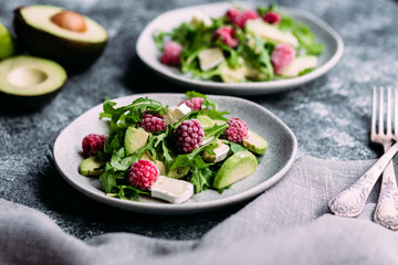 Salad with arugula, avocado, raspberries and brie cheese