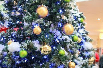 Obraz na płótnie Canvas Decorated Christmas tree with colored noel ball with blurred background.- Image