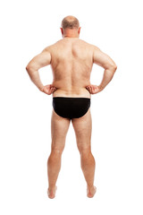 Fat man in shorts. Back view. Full height. Isolated over white background. Vertical.
