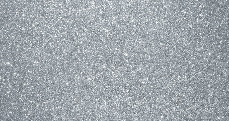 Silver glitter background, sparkling shimmer glow particles texture. Silver light sparks and glittering foil sequins background with shine sparks glare