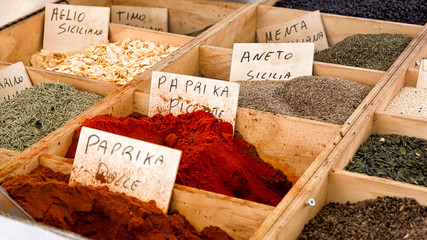 Spices, fruits and almonds on a market in Ortigia, Italy