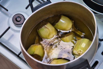 Caramelizing natural artichokes with boiling olive oil with a faint flavor of natural carbon.