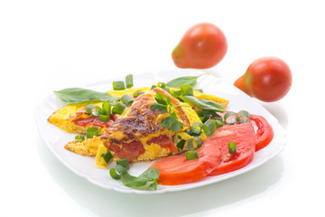 fried omelet from homemade organic eggs with tomatoes and green onions