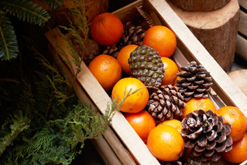 Oranges, tangerines and Christmas tree cones as New Year tree decoration