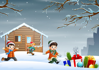 Cartoon children enjoying winter christmas in front the house
