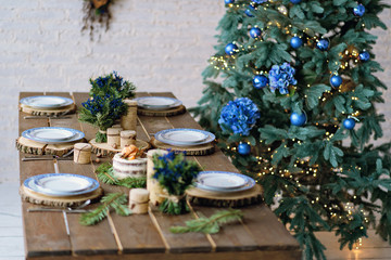 Beautiful New Year's interior in rustic style. Table decoration for the New Year holiday.