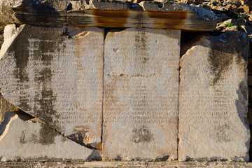 Latin inscription on stone blocks on Curetes street of ancient Ephesus Turkey