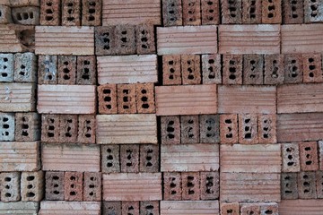 Red brown vintage abstract hollow brick arrangement in a row pattern texture background 