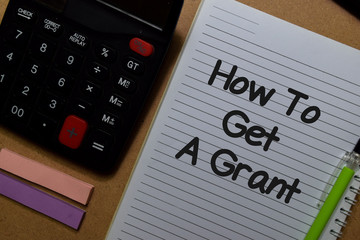 How To Get A Grant write on a book isolated on Office Desk