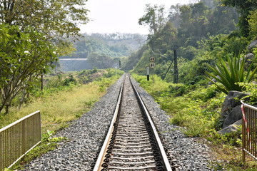 Fototapeta na wymiar perspective view railways from station to mountain in Thailand