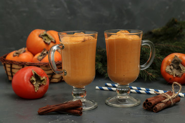 Homemade smoothie of persimmon with cinnamon on a dark background, horizontal orientation