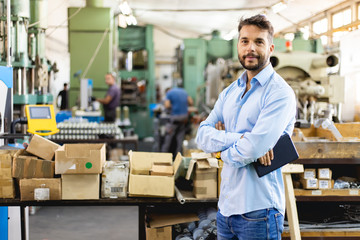 Businessman in factory. Engineer in production