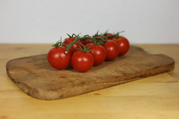 Tomatoes on a wooden plate close up