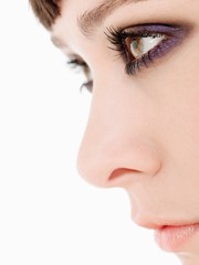 Young Woman Wearing heavy Eye Makeup side view close up