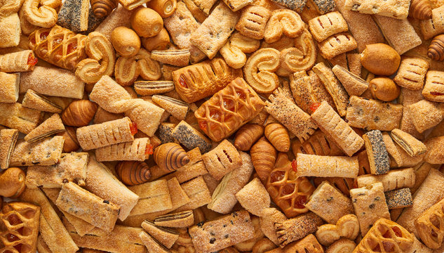 Unhealthy food concept background High resolution quality texture of pastry Top view of a variety of cookies Texture of the cookie in the studio Cookies wallpaper background Horizontal photo.