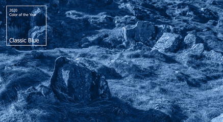 Color of the year 2020 concept, classic blue colored trend for your design. Copy space. COY2020. Ancient mountain rock landscape in Scotland. Beautiful scottish backdrop