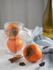 Delicious fresh persimmon fruit on a gray table. Close-up. Ingredients for persimmon jam.