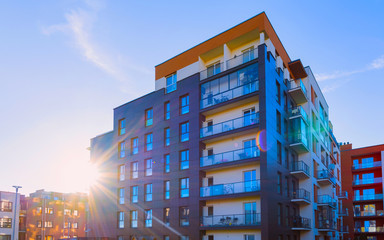 Fototapeta premium Residential Apartment house facade architecture with outdoor facilities sunlight reflex