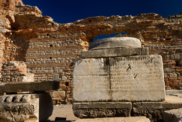 Greek inscription on stone column base at the brothel wall at Curetes and Marble streets Ephesus...