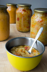 Canned vegetable salad in a dish and in jars