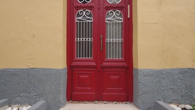 Red wooden door in Corfu Town on the island of Corfu, Greece