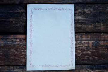 Empty list or scroll. On a wooden background.